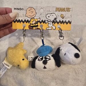 Peanuts Plush Keychain Set - Yellow Woodstock, White/Black Snoopy, Blue Hat Dog